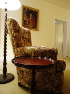 Tapestry armchair and side table in the cottage lounge at White & Red Rose Cottages