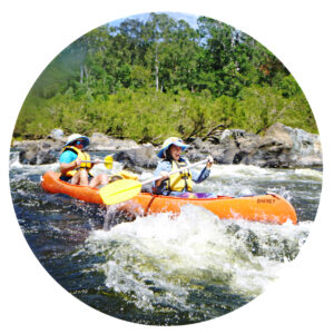 Family rafting through white water on a Journey Outdoors in Nature adventure