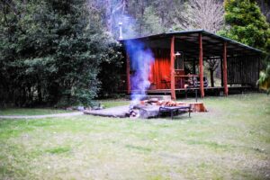 Campfire burning beside the camp shelter at Clarence River Wilderness Lodge