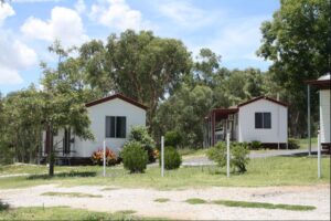 Row of white cabins at Glenlyon Dam Tourist Park