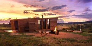 Evening campfire glow beside the Gabarraa cabin under a sunset sky