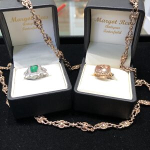 Emerald and morganite rings in presentation boxes at Margot Rees Antiques