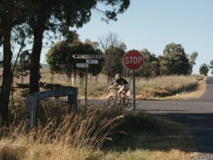 Cyclist turning at a rural stop sign on the Tenterfield Northern Loop