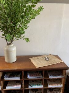Sideboard with vase of greenery and vintage papers at the Old Council Chambers