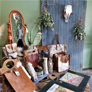 Cowhide bags and leather goods styled with rustic props at Matilda Made Leather