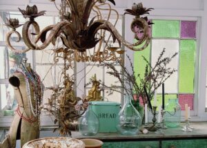 Chandelier and stained glass above the vintage wares counter at White Cottage Flower Farm
