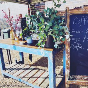 Potted plants and chalkboard menu at the Tenterfield Farmers and Producers Market