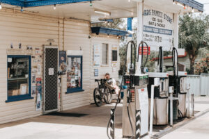 Cyclist at the old Texas general store fuel pumps on the Texas Lasso route