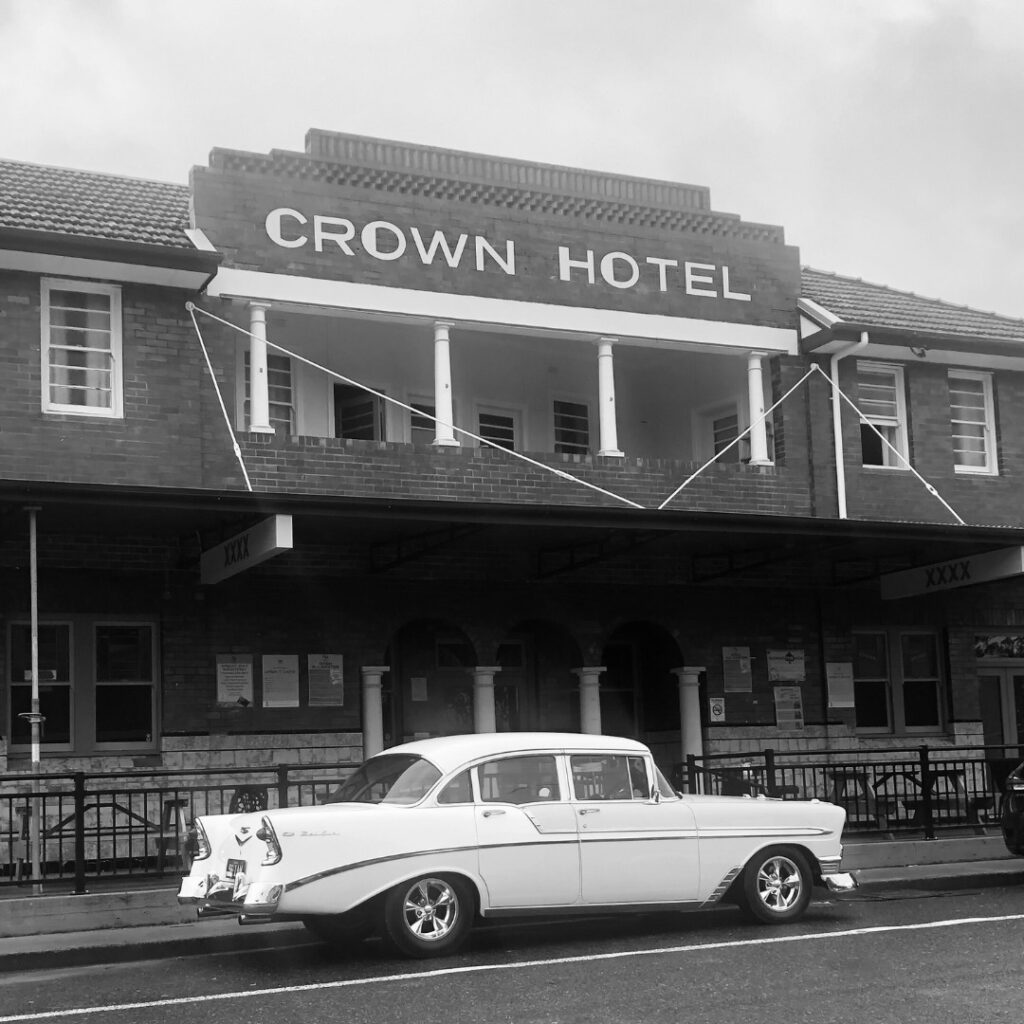 Historic black and white photo of the Crown Hotel Urbenville with a 1950s car out front