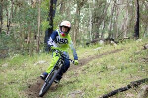 Mountain biker riding a bush trail near Legume