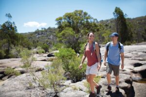 Hikers walking across granite slabs on the Mount Norman hike, Girraween